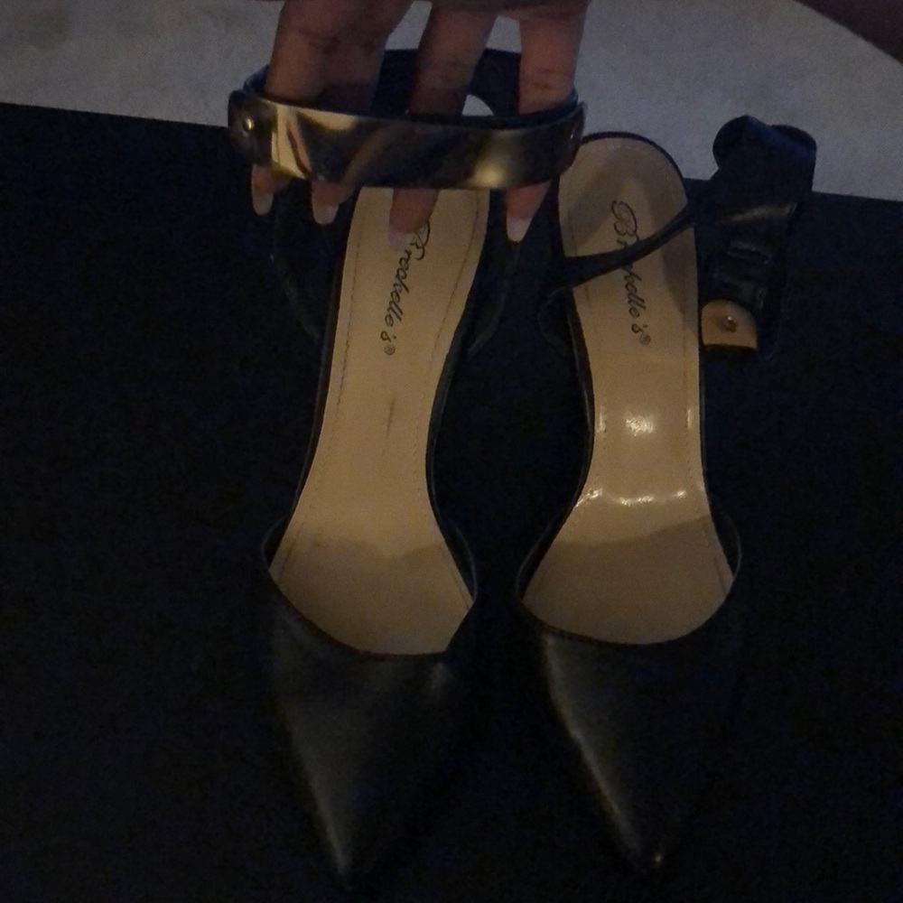 Ankle strap heels with gold detail on strap.